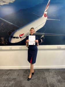Aviation student standing in front of a picture of a British Airways Euroflyer