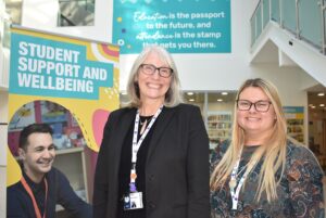 Two members of the student experience and wellbeing team in the atrium at Redcar and Cleveland College.