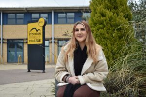 Student sitting outside college