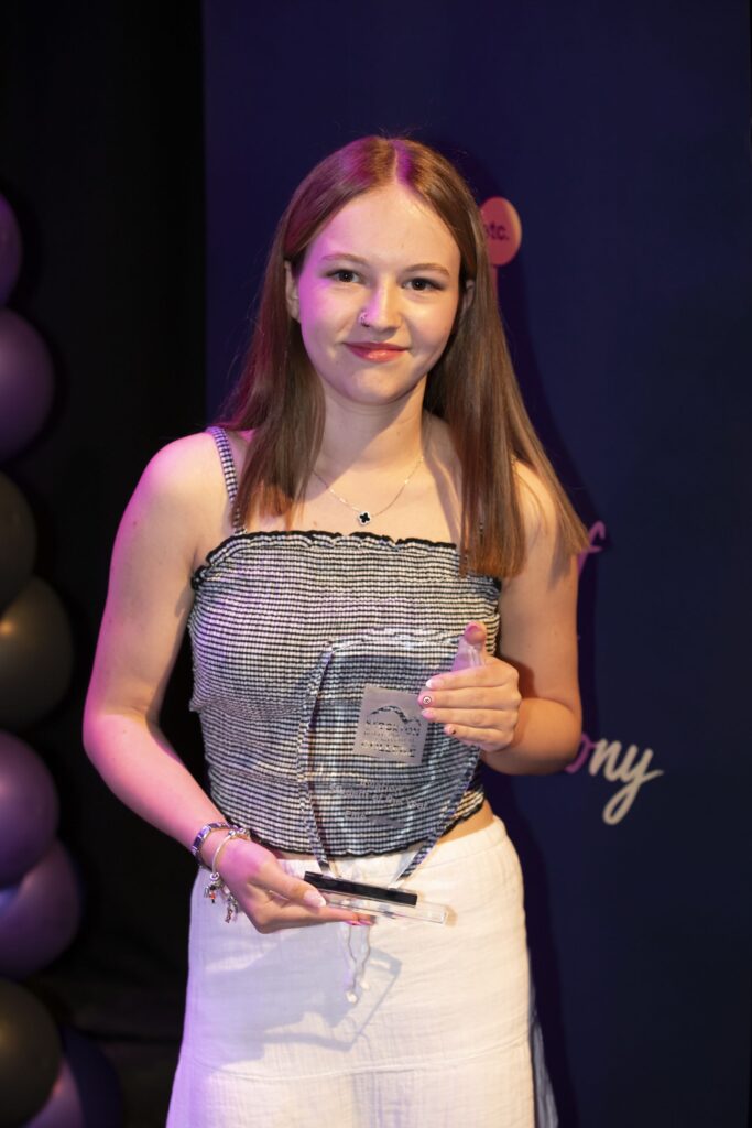 Student with trophy.