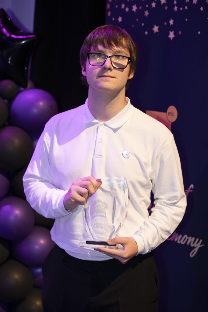 Student with trophy.