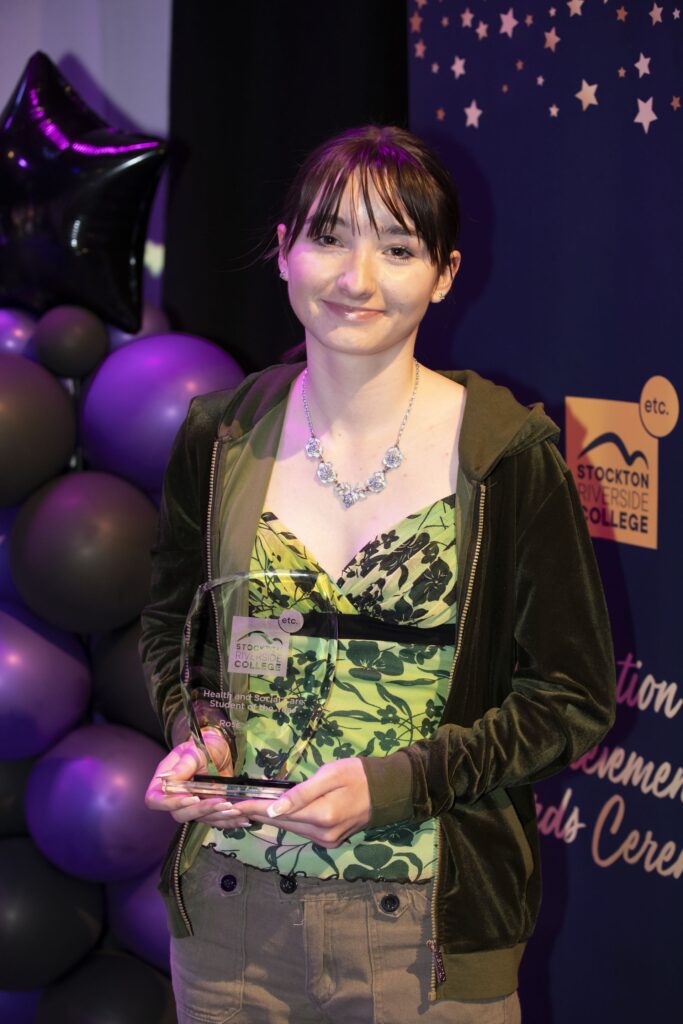 Student with trophy.