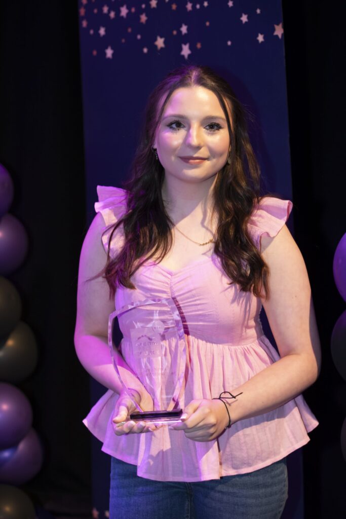 Student with trophy.