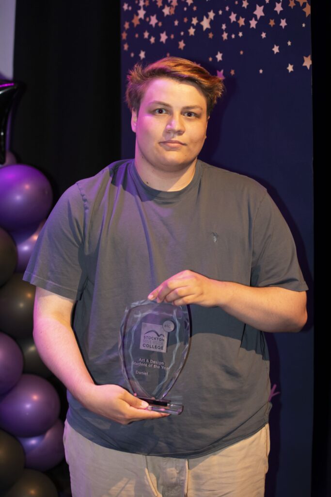 Student with trophy.