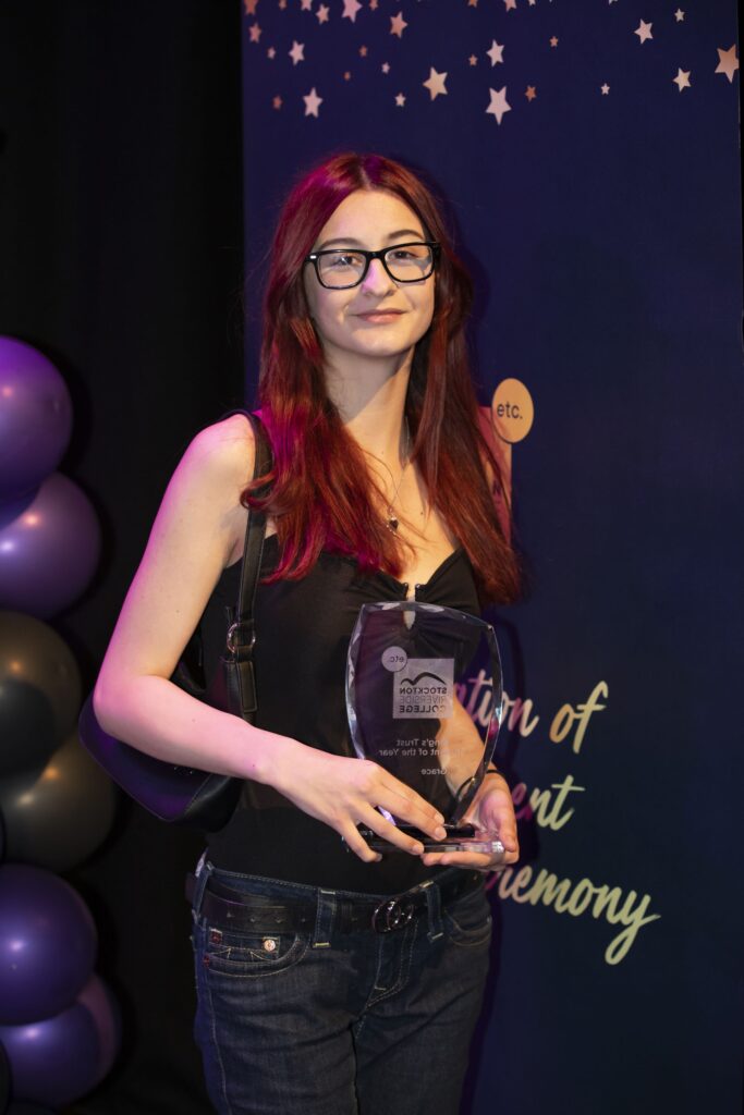 Student with trophy.