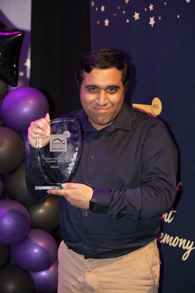Student with trophy.