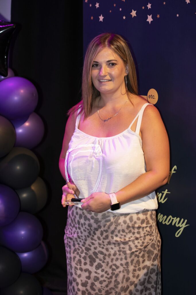 Student with trophy.