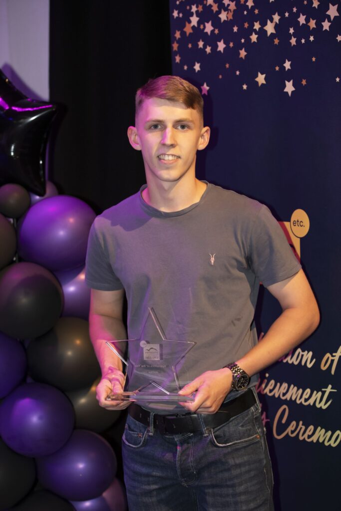 Student with trophy.