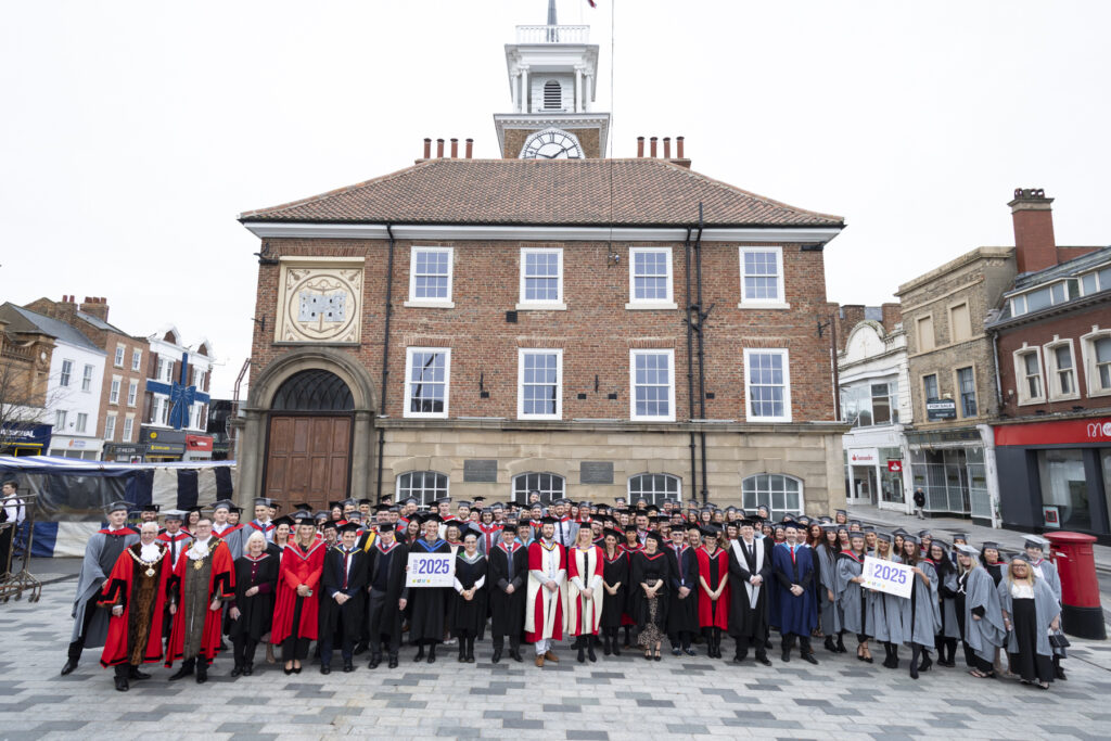 College graduates and staff standing outside Stockton Town Hall