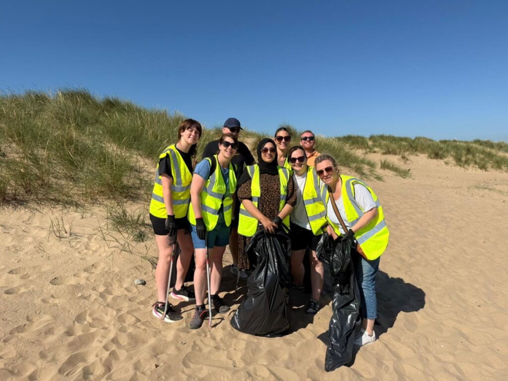 Group of Etc. staff taking part in a beach litter pick.