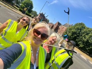 Staff in high vis vests taking part in litter pick.
