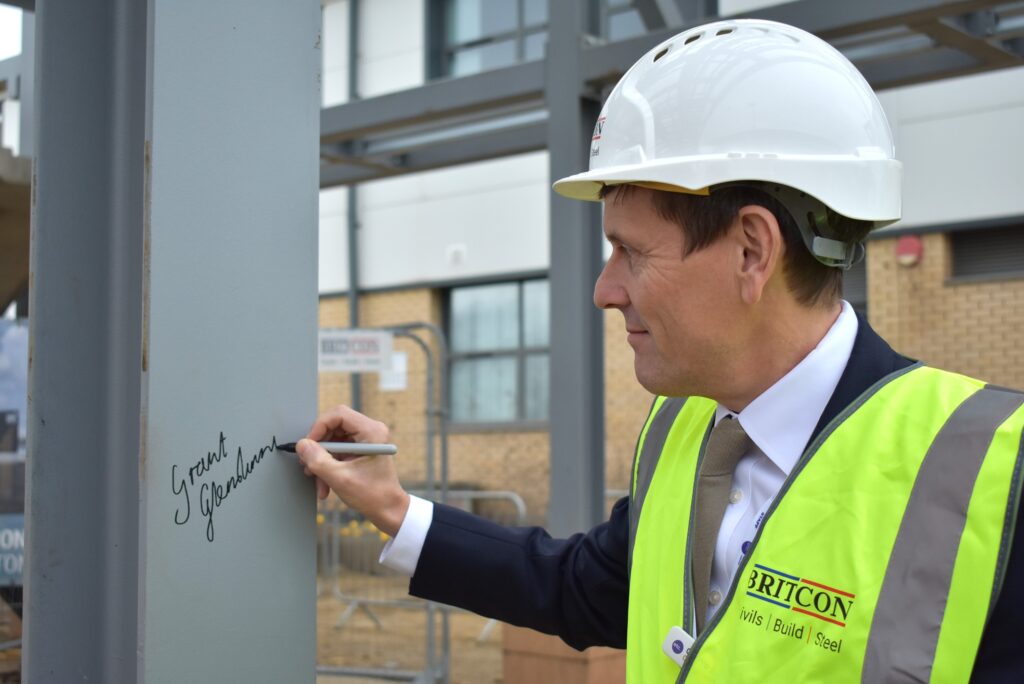Etc. chief executive Grant Glendinning signing the steel at new NETA facility