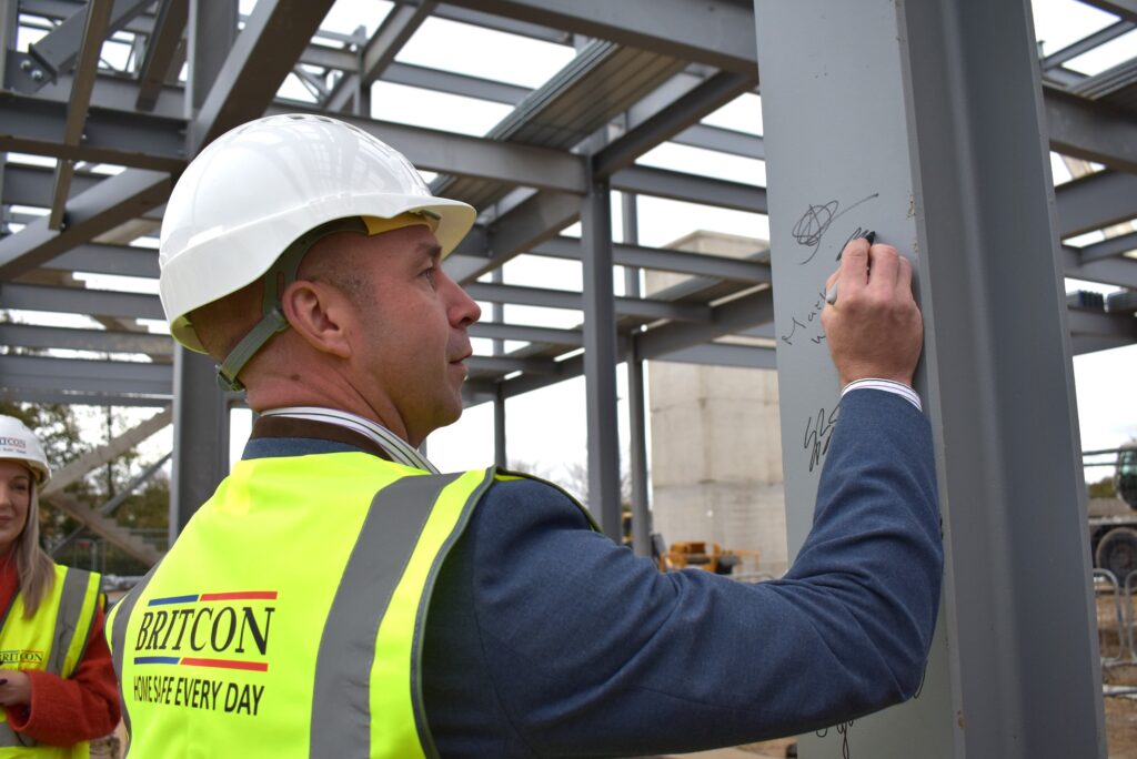 Rory McIntosh signing the steel at new NETA facility