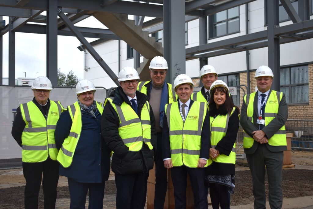 Guests and staff signing the steel at new NETA facility development