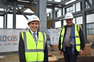 Two men in hard hats and high vis vests standing in front of new NETA Training framework