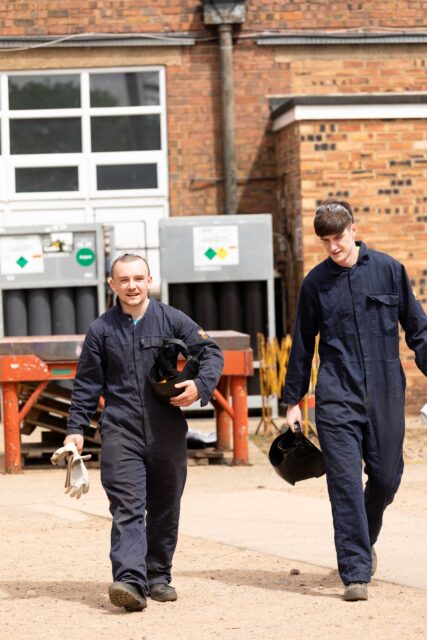 Two NETA students walking through the grounds