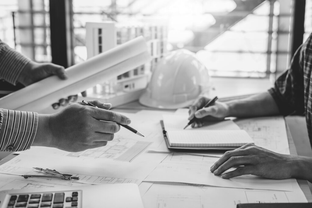 Construction and structure concept of Engineer or architect meeting for project working with partner and engineering tools on model building and blueprint in working site.